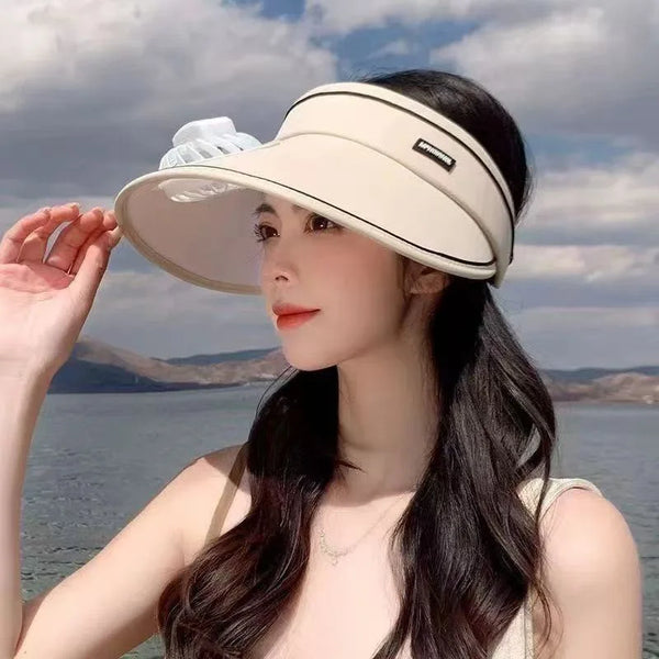 Women Rechargeable Cooling Fan Sun Visor worn by a woman by the water, showcasing its stylish and functional design.