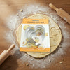 Classic 5 Piece Stainless Steel Cookie Cutter Set on a wooden surface with rolled dough and rolling pins.