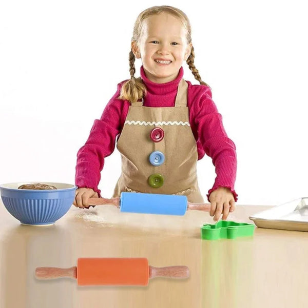 Child using a Non-Stick Wooden Handle Silicone Rolling Pin while baking, smiling and having fun in the kitchen.