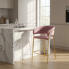 Upholstered Bar Stool with Curved Back and Black Metal Frame in kitchen setting with marble counter.