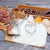 3 Piece Stainless Steel Heart Shape Cookie Cutter Set displayed on a wooden board with flour and baking ingredients.
