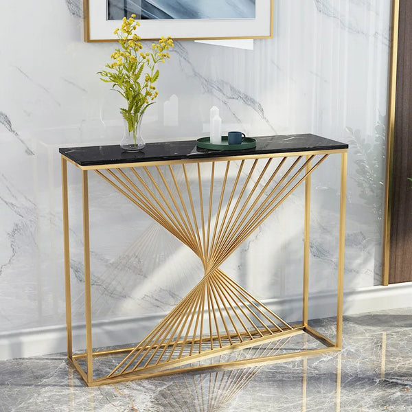 Nordic Golden Marble Console Table with gold geometric base and black top, styled with flowers and decorative items.