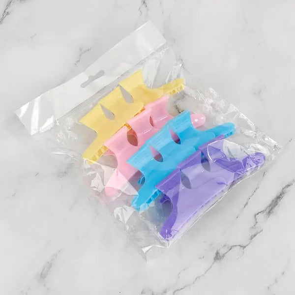 12 Piece Butterfly Hair Sectioning Clips in a clear packaging with various colors including yellow, pink, blue, and purple.