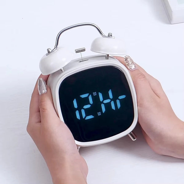 Digital Loud Bell Alarm Clock with Snooze displaying time in hands of a user with sleek design.