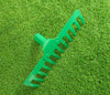 14 Teeth Green Garden Rake on green grass surface, perfect for leveling soil and clearing garden debris.