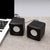 Mini USB Wired Speaker PC Speaker next to a laptop on a table, showcasing its compact design and modern style.