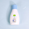 Vitamin E Soothing Baby Massage Oil in a bottle with a penguin design on a light blue background.