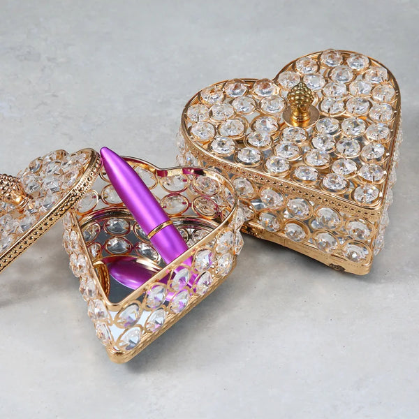 Vintage Crystal Metal European Love Princess Jewelry Box with gemstones and pink pen on a smooth surface