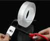 Close-up of Double-Sided Nano Gel Grip Tape being cut with scissors for versatile use.