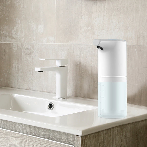 Automatic Soap Dispenser next to a modern sink in a clean bathroom setting.