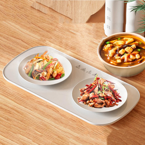 Portable Electric Food Warming Tray with two bowls of hot food on a wooden table.