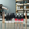 Essential Amino Acid-Infused Hair Care products displayed in a modern salon with shimmering bottles and elegant packaging.