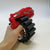 Manual Soft Bullet Toy Blaster with Rotating Drum in a child's hand featuring a red and black design.
