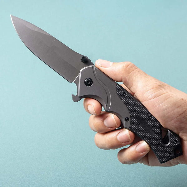 G10 Stainless Steel Folding Hunting Knife held in hand, showcasing its sleek design and sharp blade.