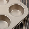 Close-up of 6 Cup Non-Stick Carbon Steel Muffin Pan with three muffin cavities.