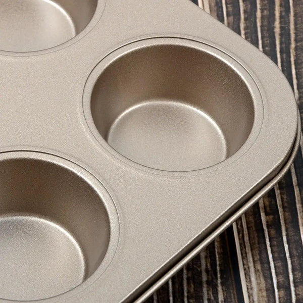 Close-up of 6 Cup Non-Stick Carbon Steel Muffin Pan with three muffin cavities.