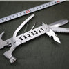 Outdoor Multi-Function Mini Claw Hammer lying on green fabric next to a measuring tape, showcasing its versatile design.