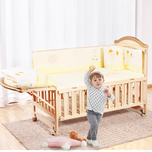 Child playing near Multi-functional Wood Baby Crib Kids Cot with soft bedding and safety bumpers in a cozy room.