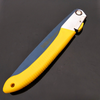 Folding Carbon Steel Garden Pruning Saw with yellow handle for easy outdoor cutting and trimming.