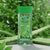 Aloe Vera Anti-Aging Body Massage Oil in a bottle surrounded by fresh green aloe leaves for skincare.