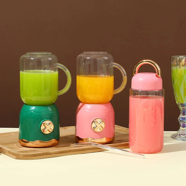 Portable USB Rechargeable Double Cup Juicer with green and yellow smoothies in cups and a pink bottle.