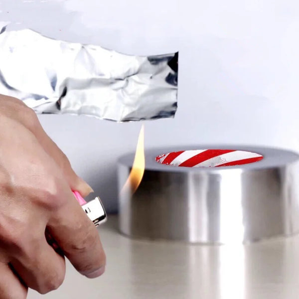 A hand using a lighter near heat resistant aluminum tape to demonstrate its fire resistance and durability.