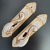 Modern White European Door Handle set featuring ornate design with gold accents on a sleek background.