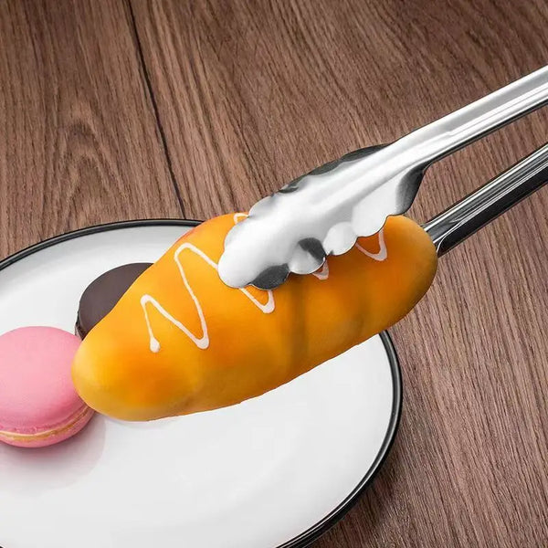 3-Piece 12-Inch Stainless Steel BBQ Tong Set holding a pastry on a plate with colorful macarons.