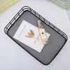 Metal Wire Grid Basket Organizer showcasing a sleek black design, holding a magazine and a perfume bottle.