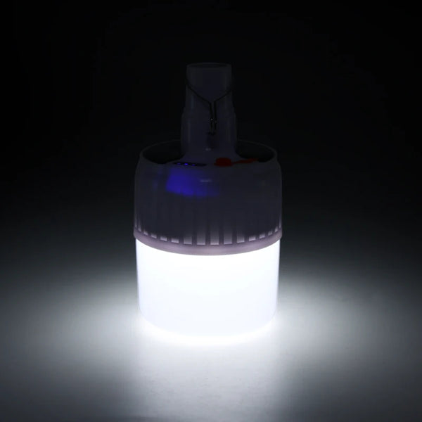 Portable Solar LED Emergency Lamp emitting bright light in a dark setting, perfect for outdoor activities and emergencies.