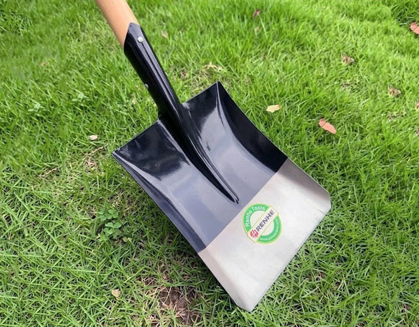 Heavy Duty Steel Garden & Construction Digging Shovel resting on grass, showcasing its durable design.