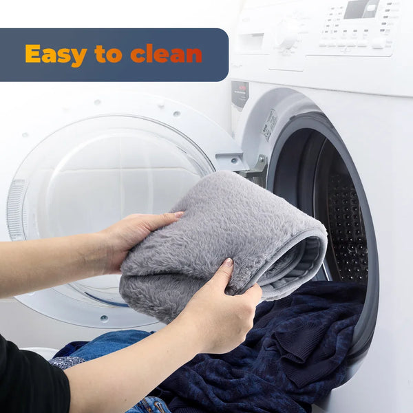 Person placing a USB Electric Heating Belt in the washing machine, showcasing easy cleaning.