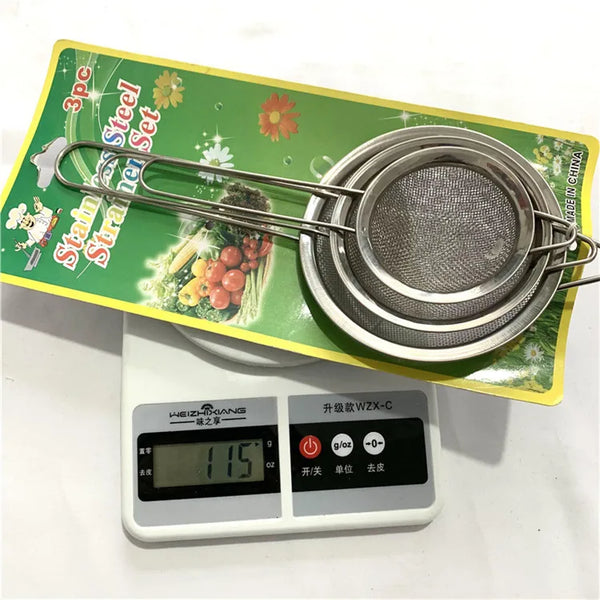 Stainless Steel Mesh Strainer Filter Spoon displayed on a kitchen scale with a packaging background.