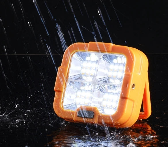 Portable LED Solar Power Flood Light FA-D6 T05 in the rain, providing bright and reliable outdoor lighting.