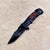 Non-Slip Stainless Steel Folding Meat Knife with a sleek black design on a soft surface.