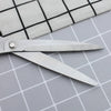 Close-up of 11-inch Stainless Steel Clothing Scissors on a checkered fabric background.