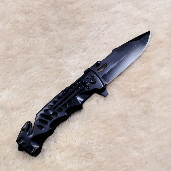 Non-Slip Stainless Steel Folding Meat Knife on a soft surface, highlighting its sleek design and sharp blade.