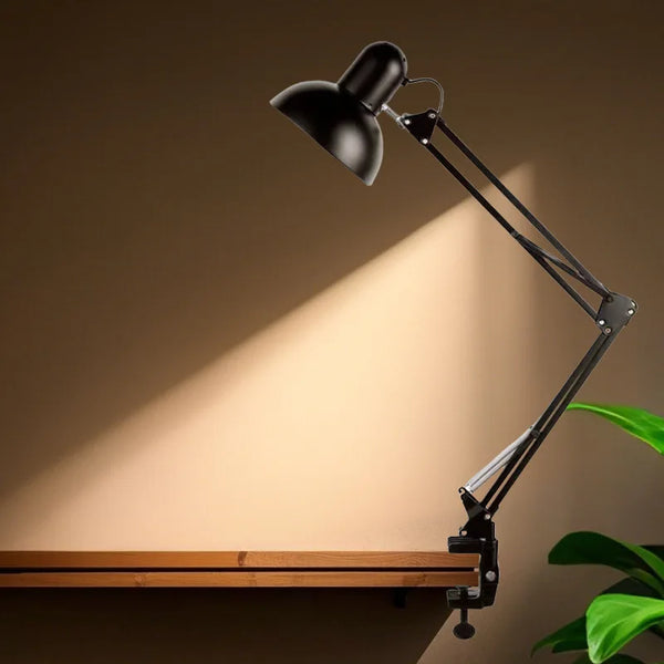 Flexible Adjustable Swing Arm Clip Desk Lamp providing focused task lighting on a wooden desk.