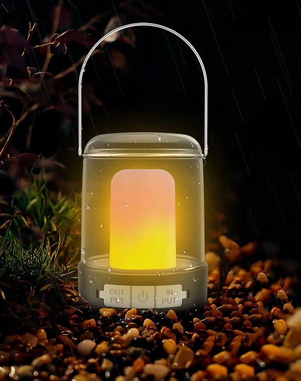 Portable USB Camping & Tent Lamp illuminated in nature amidst pebbles and plants on a rainy night.