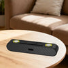 ABS-2207 Bluetooth Soundbar Speaker on a wooden table in a cozy living room setting.