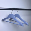 Boutique Wooden Kids Clothing Hanger in light blue, perfect for organizing children's clothing stylishly.