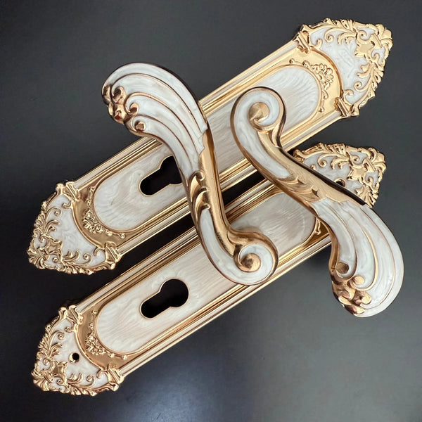 Modern White European Door Handle set featuring intricate designs in gold and white, perfect for stylish interiors.