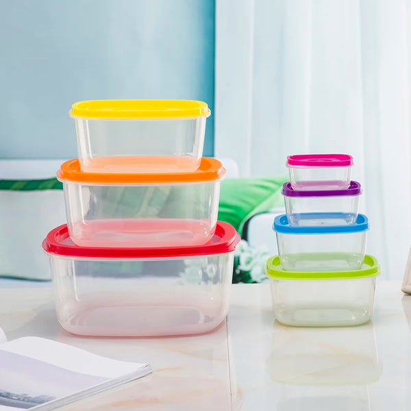 7-Piece Stackable Rainbow Food Storage Container Set displayed in vibrant colors on a kitchen table.