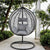 Grey Garden Outdoor Hanging Chair in a serene outdoor setting surrounded by greenery.