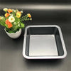 Non-Stick Square Carbon Steel Baking Pan next to a flower pot on a dark surface.