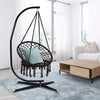 Portable Heavy Duty Outdoor Rope Hammock hanging in a modern living room with a cozy cushion.