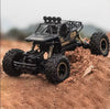 High Quality 4WD Alloy Climbing Off-Road Truck navigating rough terrain with rugged tires and detailed design.