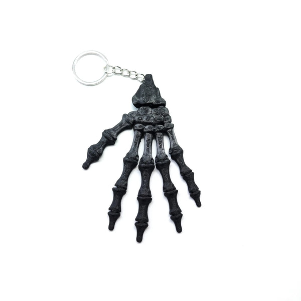 3D Printed Skull Hand Keychain Pendant featuring detailed skeleton hand design in black color.