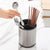 360 Rotating Stainless Steel Utensil Holder with cooking tools and chopsticks on a kitchen countertop.