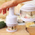 Stainless Steel Manual Food Chopper Handheld Vegetable Onion Press in use, chopping vegetables.